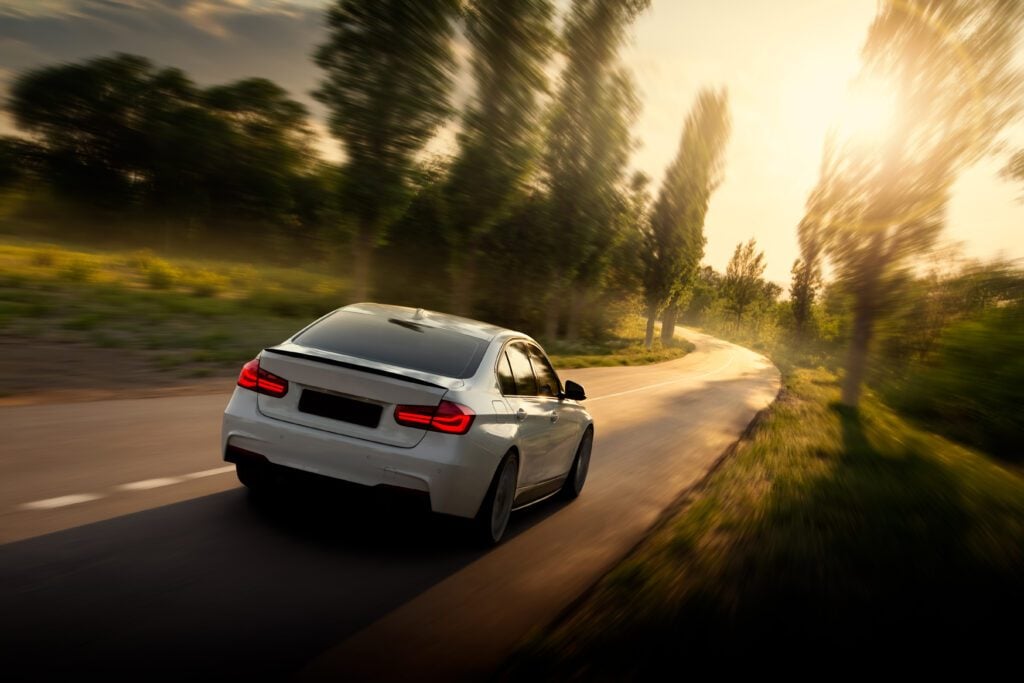 Voiture blanche qui roule sur la route